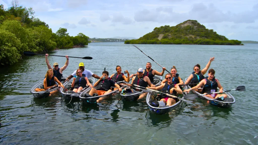 happy tour group doing kayaking eco adventures rock adventures